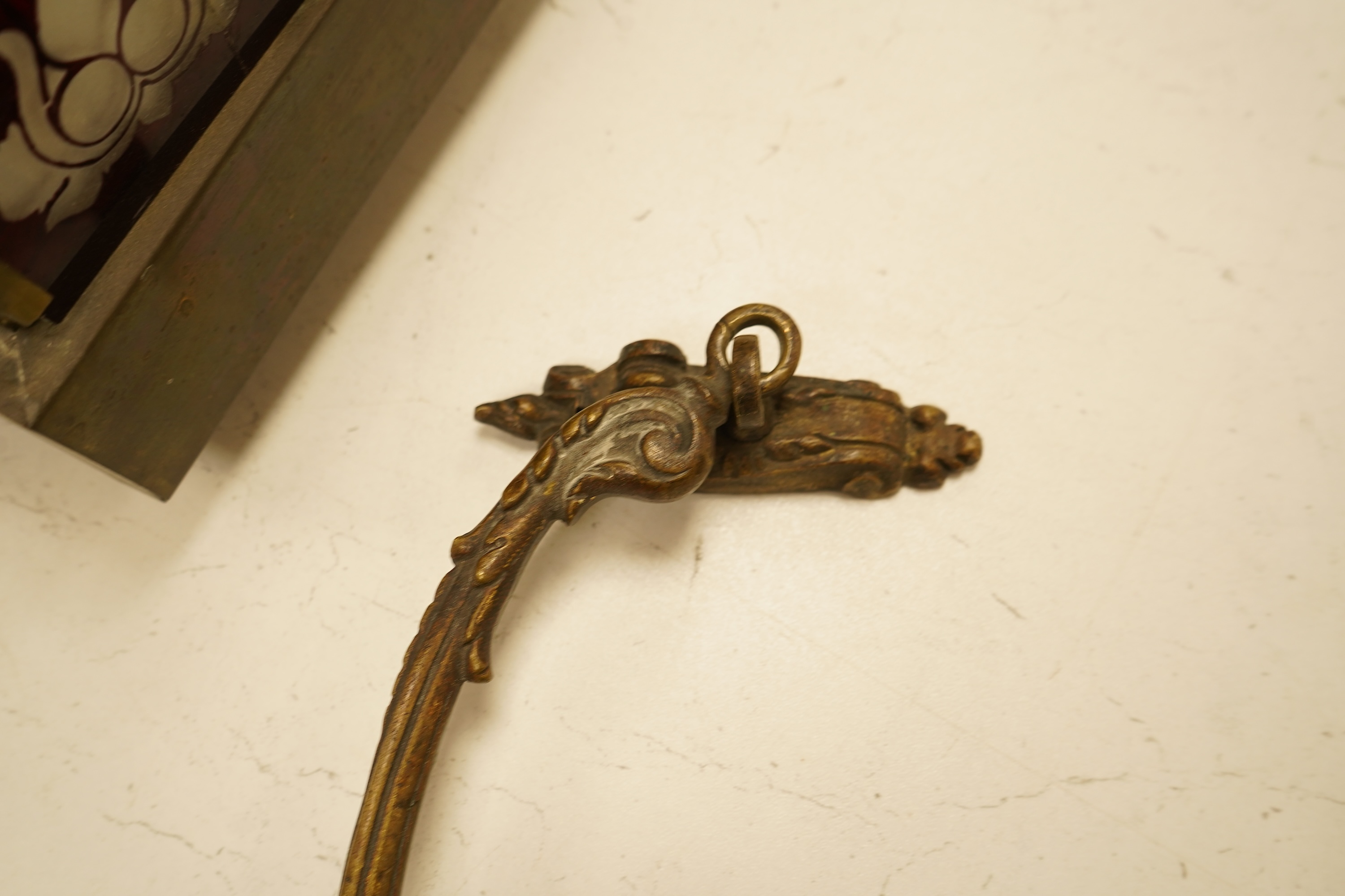 A set of four cast brass curtain tie backs, early 20th century
